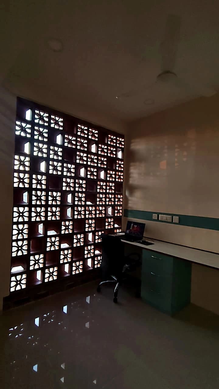 CO-WORK @ Level 3 — a cabin lit through a perforated timber screen wall