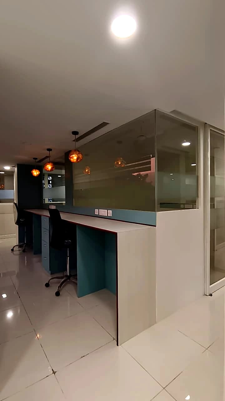 CO-WORK @ Level 3 — open desk counters under a row of glowing pendant lamps
