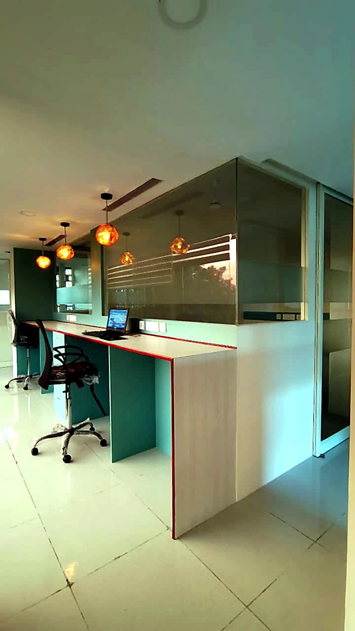 CO-WORK @ Level 3 — open desk counters lit by pendant lamps against a glazed cabin