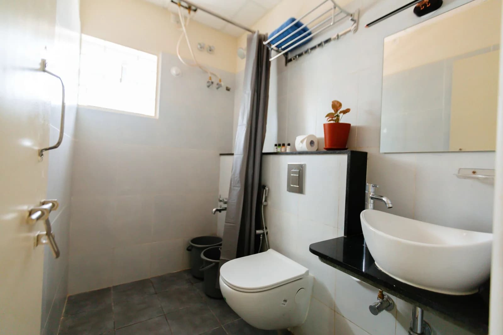 PRAAD Suites — bathroom with a counter basin and walk-in shower