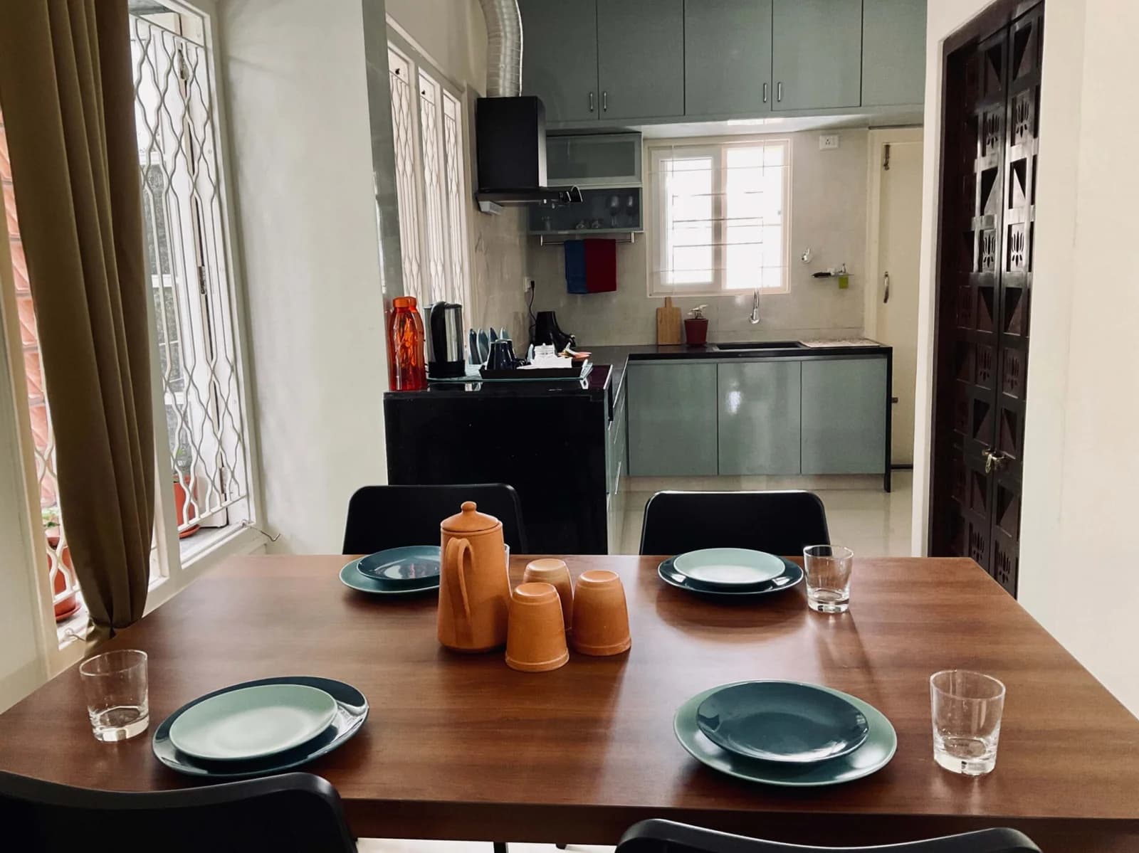 PRAAD Suites — dining table laid in front of the fitted kitchen